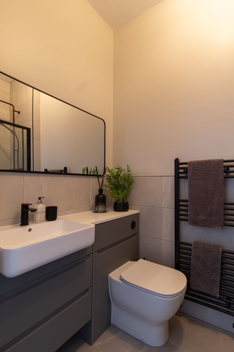 Shower room with black fittings and a heated towel rail, in Dalkeith